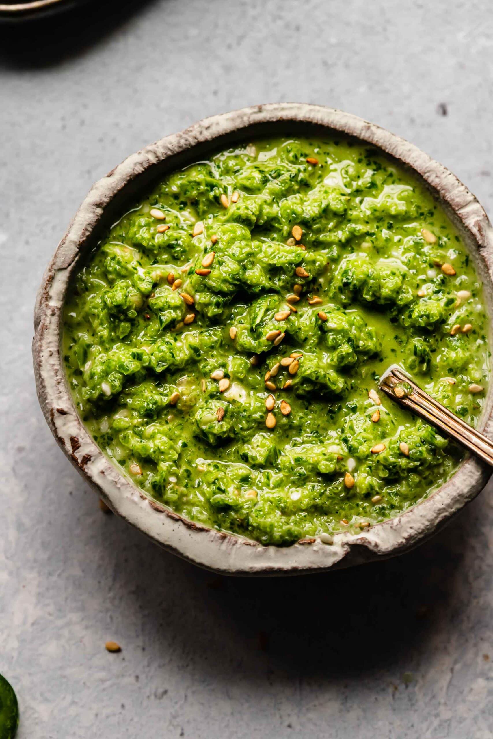 Small bowl of jalapeno sesame salsa with spoon.