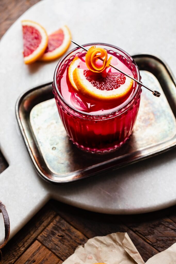 Garnished cocktail on serving tray. 