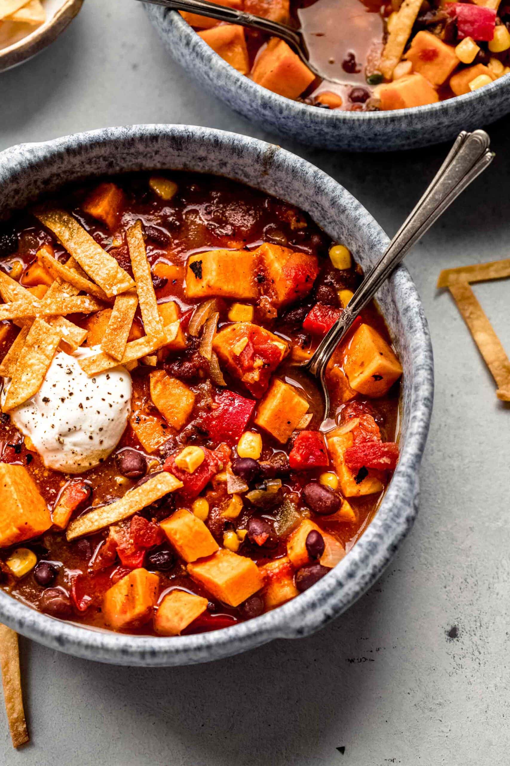 Two bowls of chili on counter.