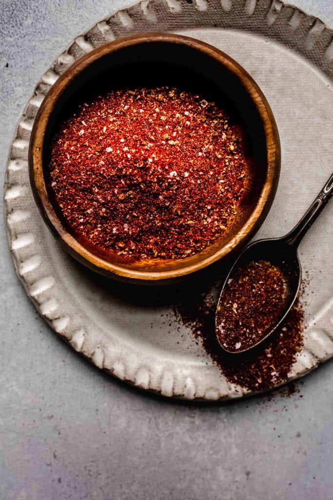 Overhead close up of chili seasoning next to spoon. 