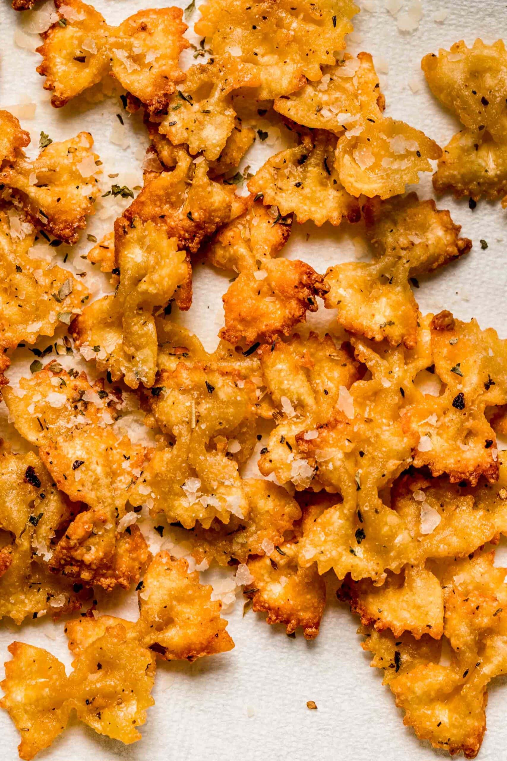 Pasta chips scattered on paper towel.