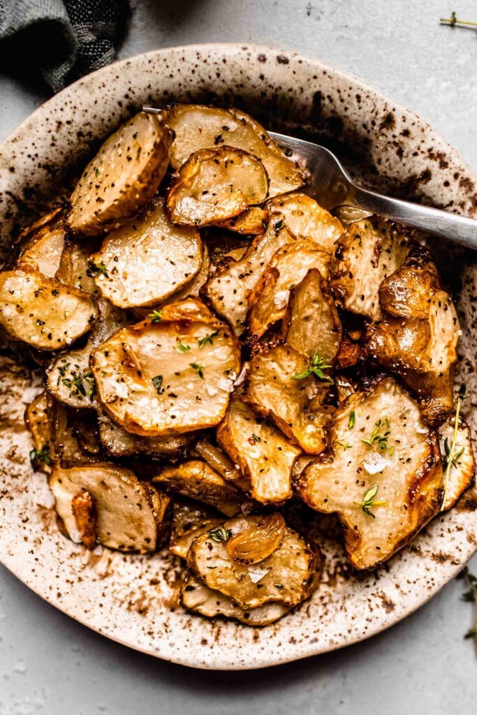 Overhead shot of cooked sunchokes in bowl.