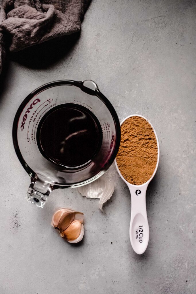 Soy, brown sugar, and garlic on counter. 