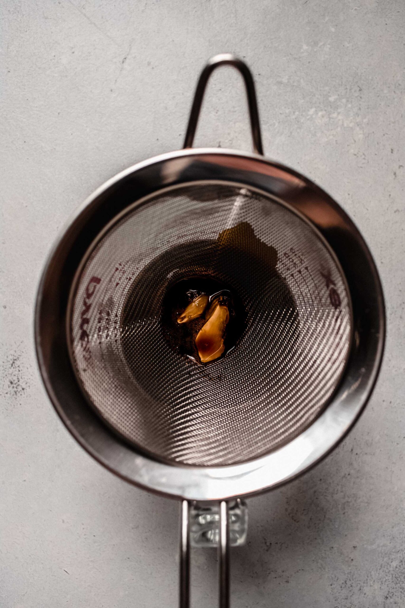 Strainer with garlic cloves. 