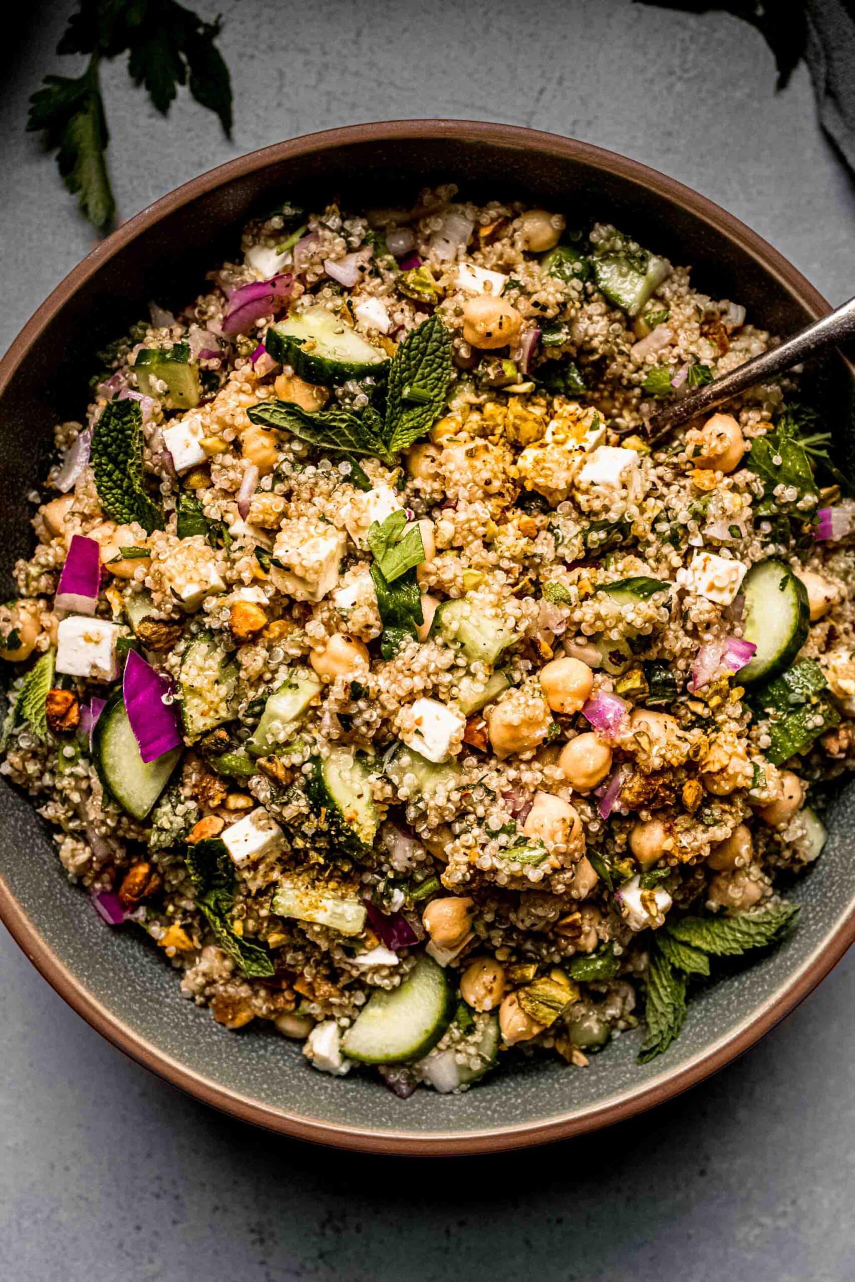 Overhead close up of prepared Jennifer Aniston Salad in green bowl.