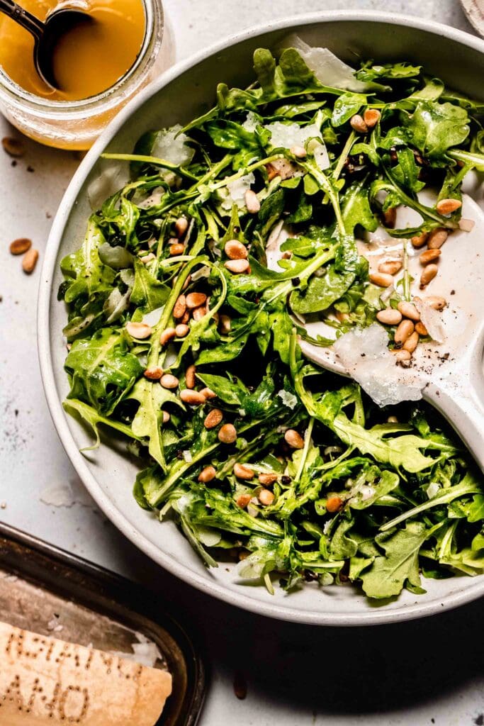 Overhead close up of prepared arugula salad.