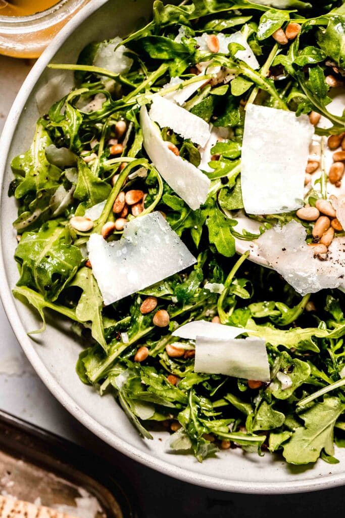 Overhead close up of prepared arugula salad.