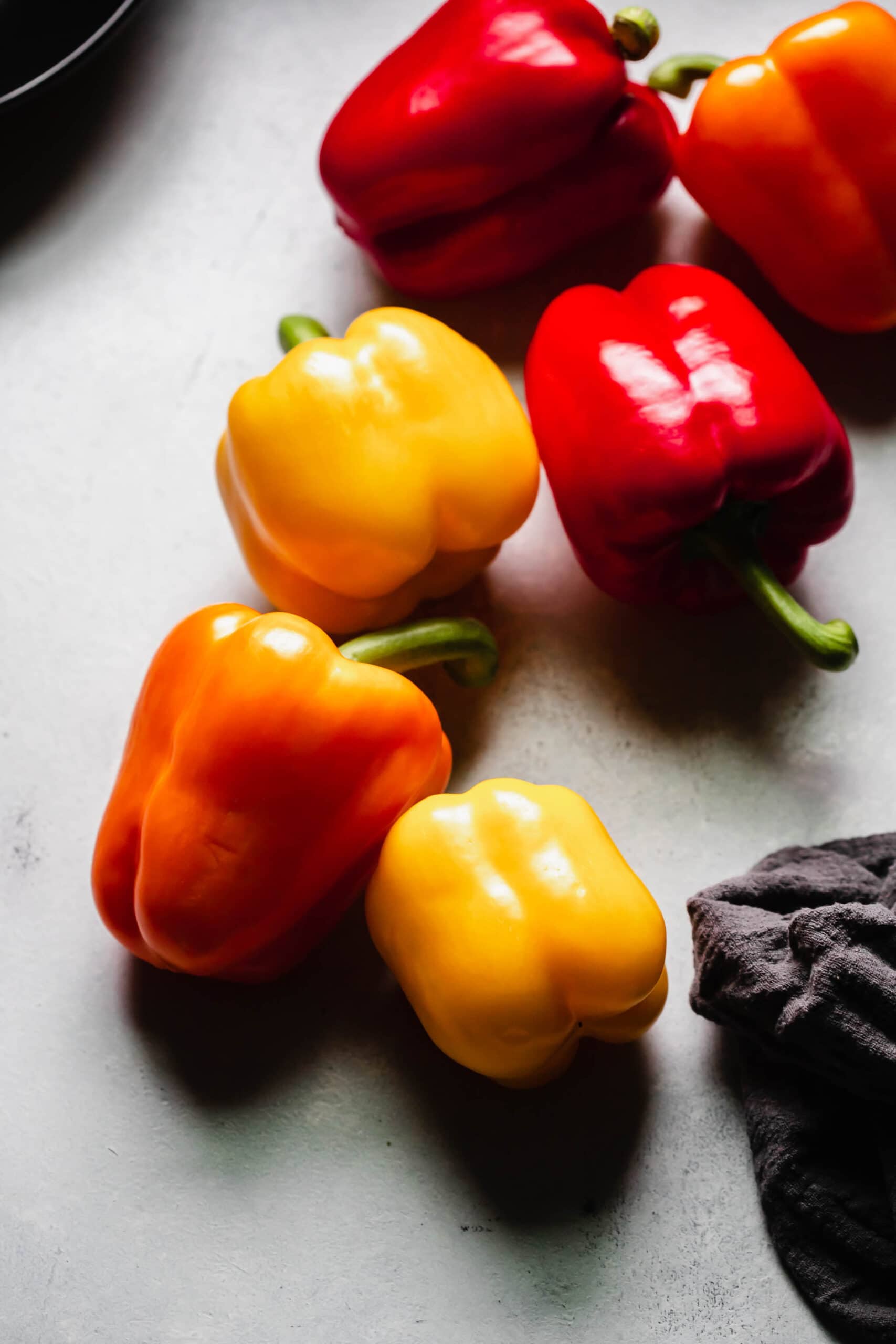 Whole peppers scattered on counter.