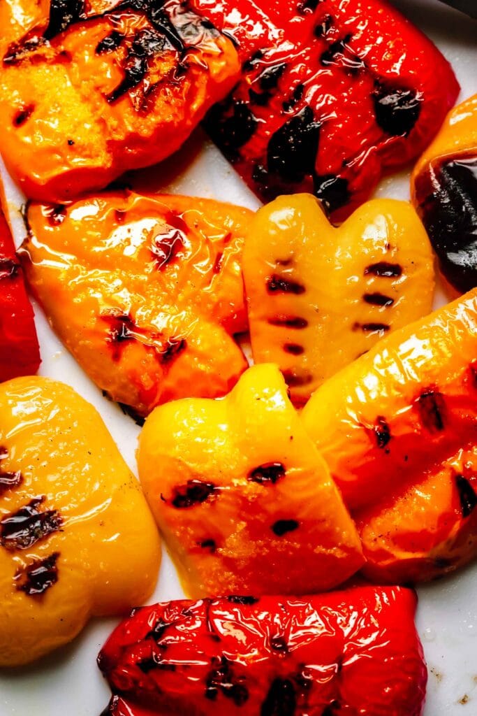 Peppers with grill marks scattered on counter.