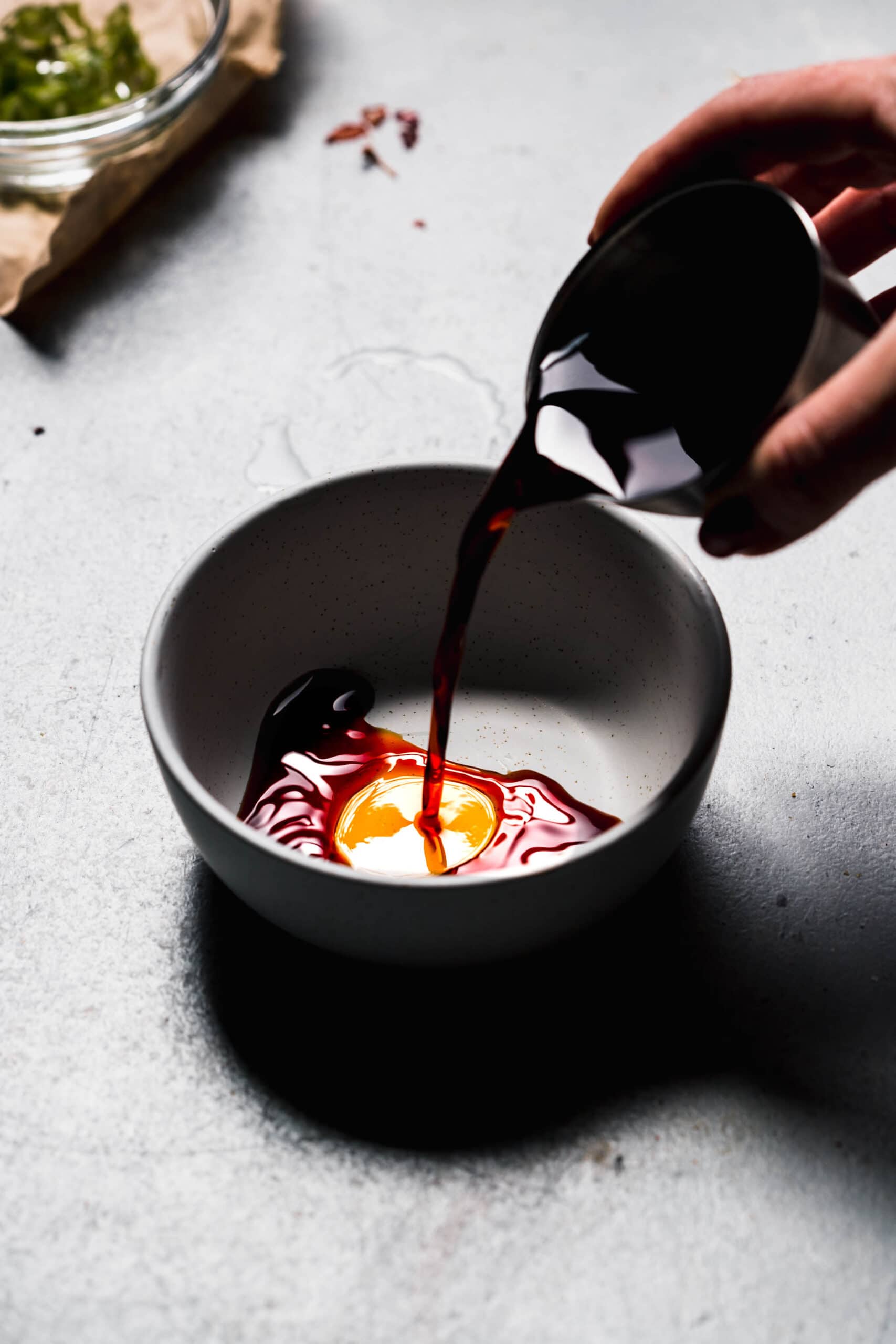 Soy sauce pouring into bowl.