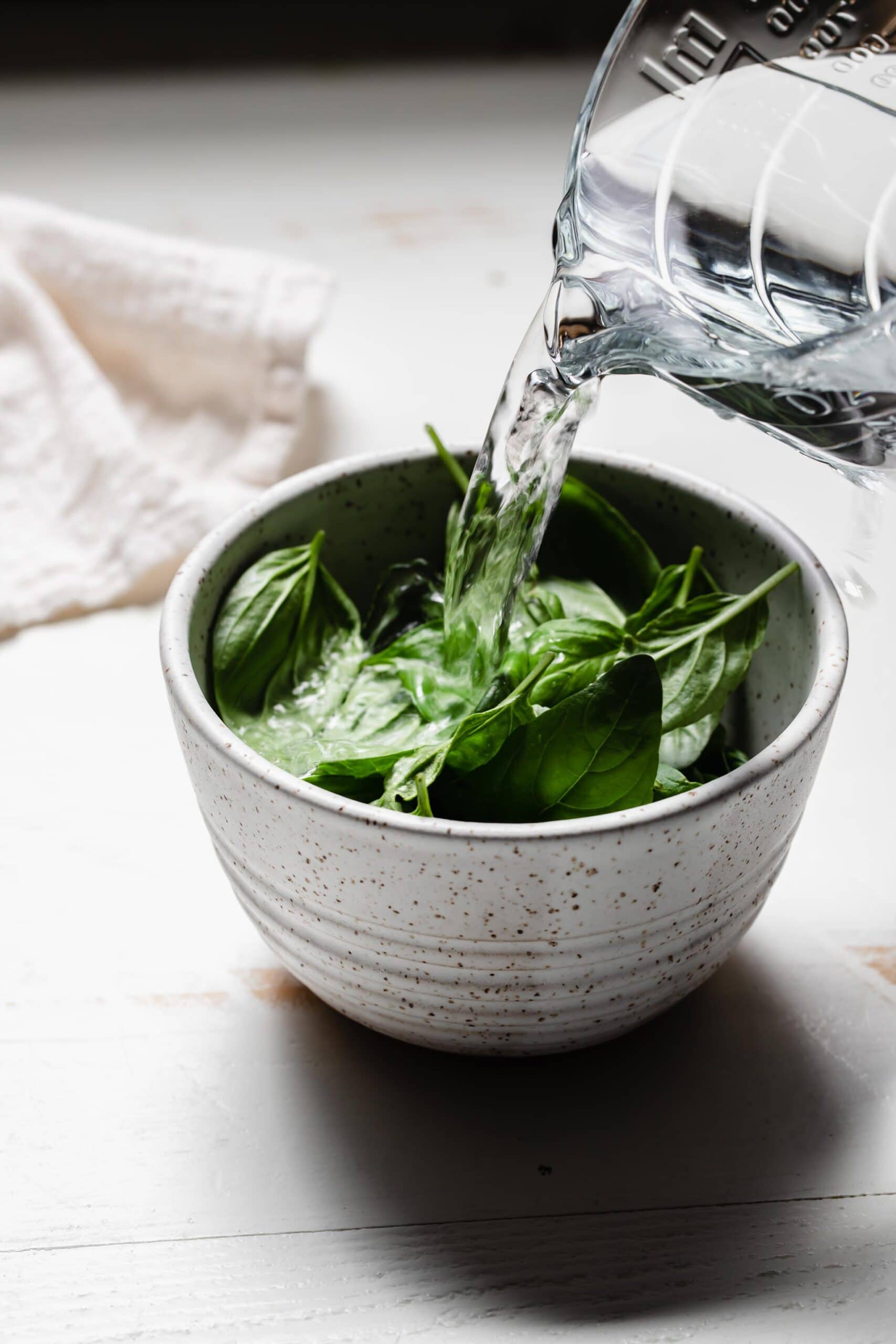 BOILING WATER BEING POURED OVER BASIL