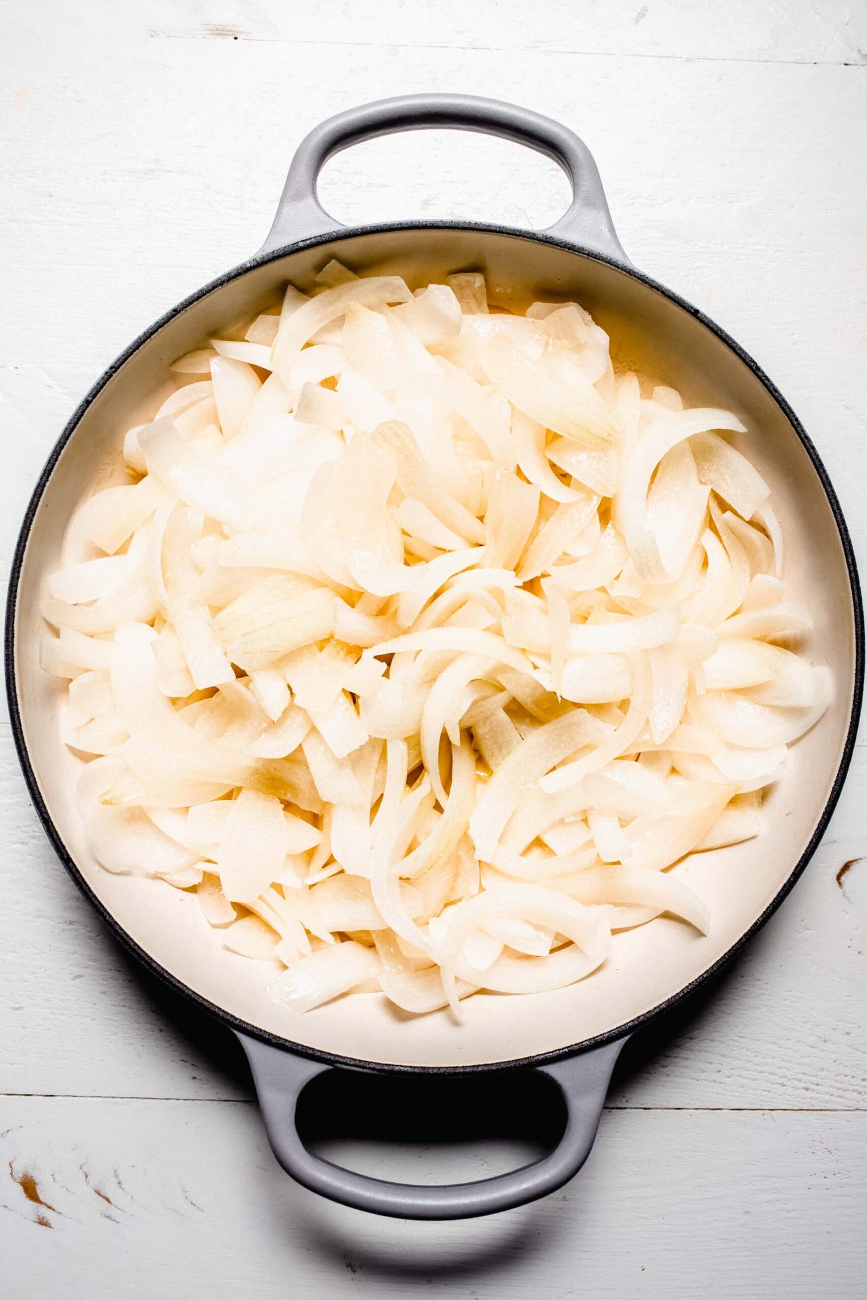 Partially cooked onions in skillet. 