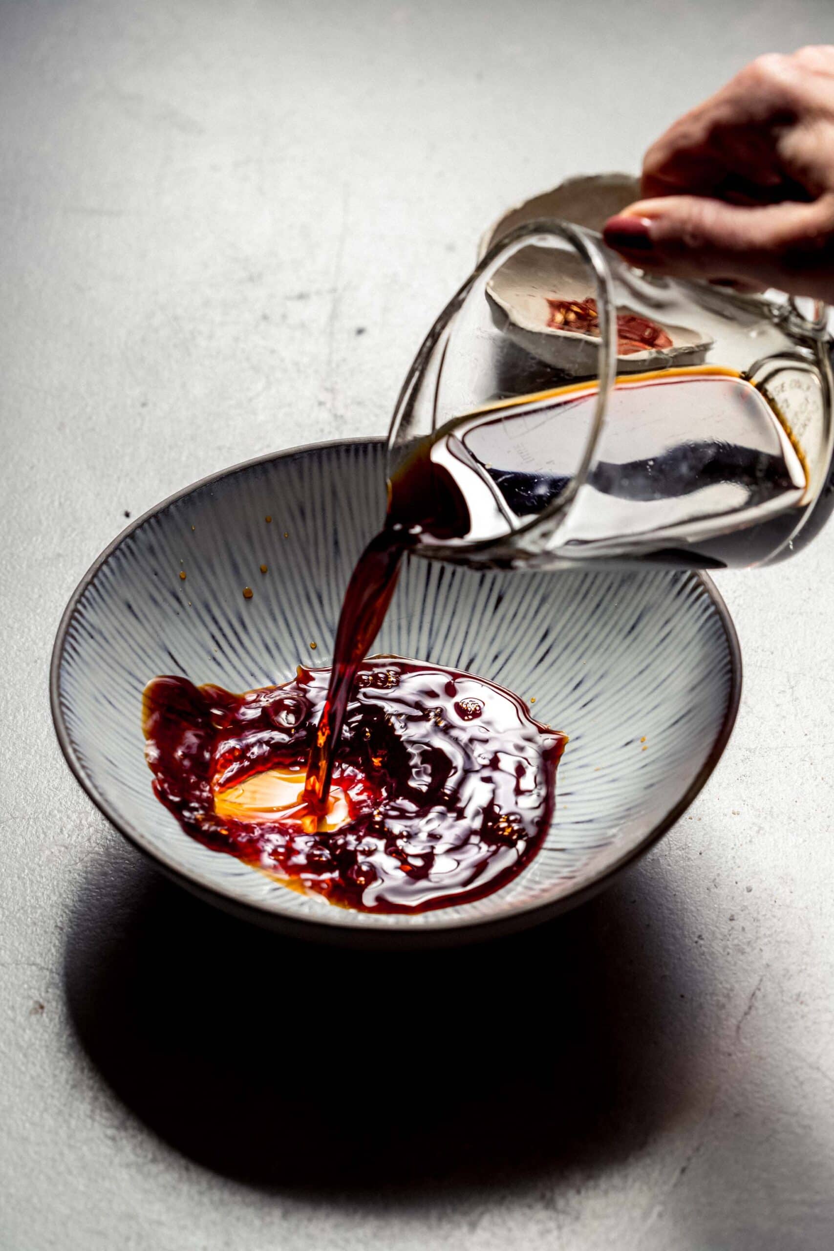 Soy sauce pouring into bowl.