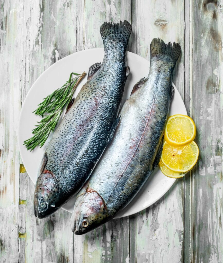 Two whole trout on serving platter.