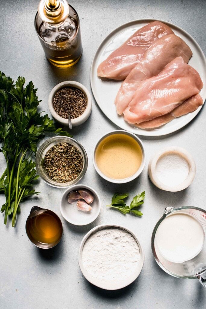 Ingredients for chicken in white wine sauce on counter.