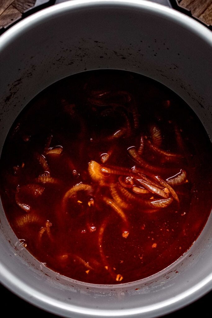 Onions, garlic, tomato paste and broth in instant pot. 