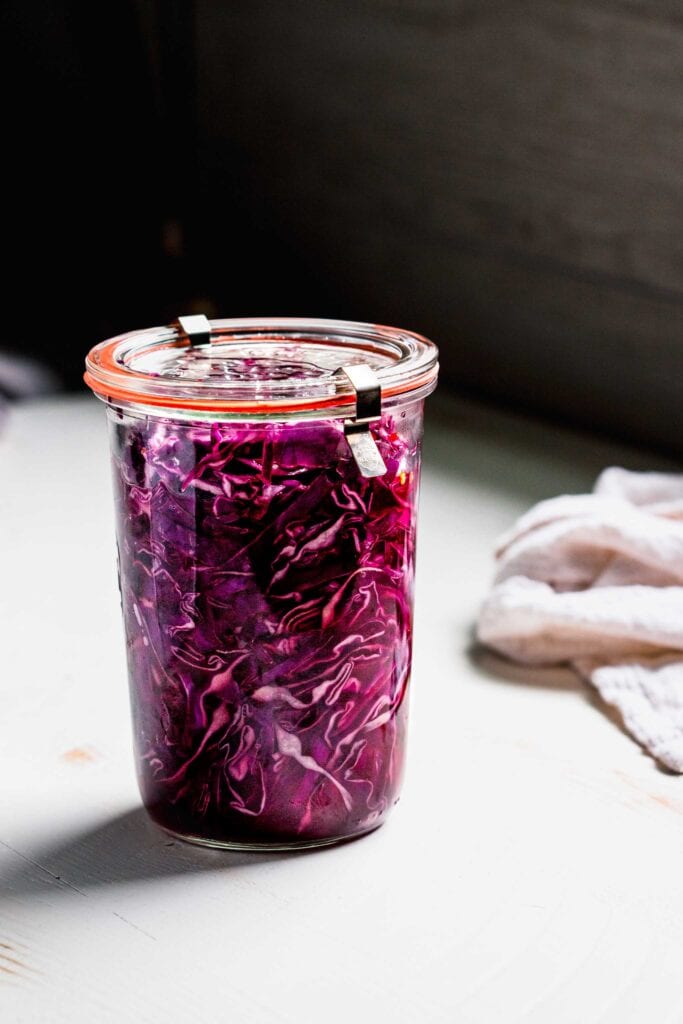 Side view of pickled cabbage in jar.