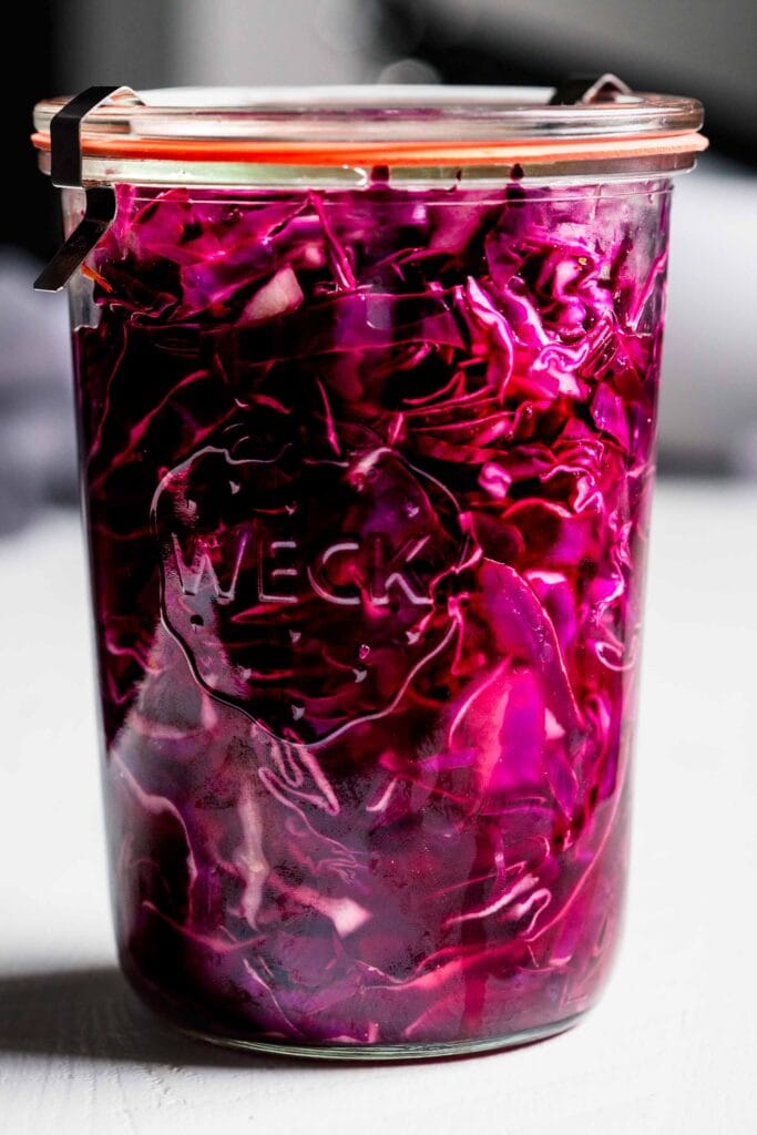 Side view of pickled red cabbage in jar.