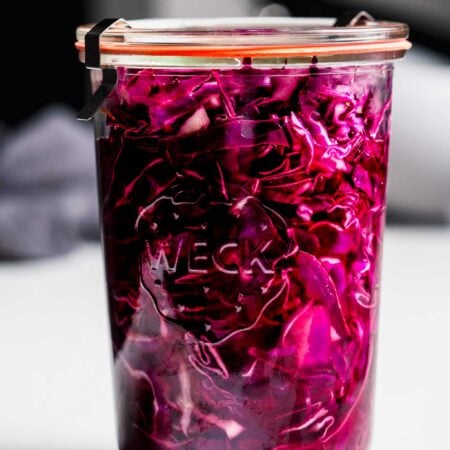 Side view of pickled red cabbage in jar.