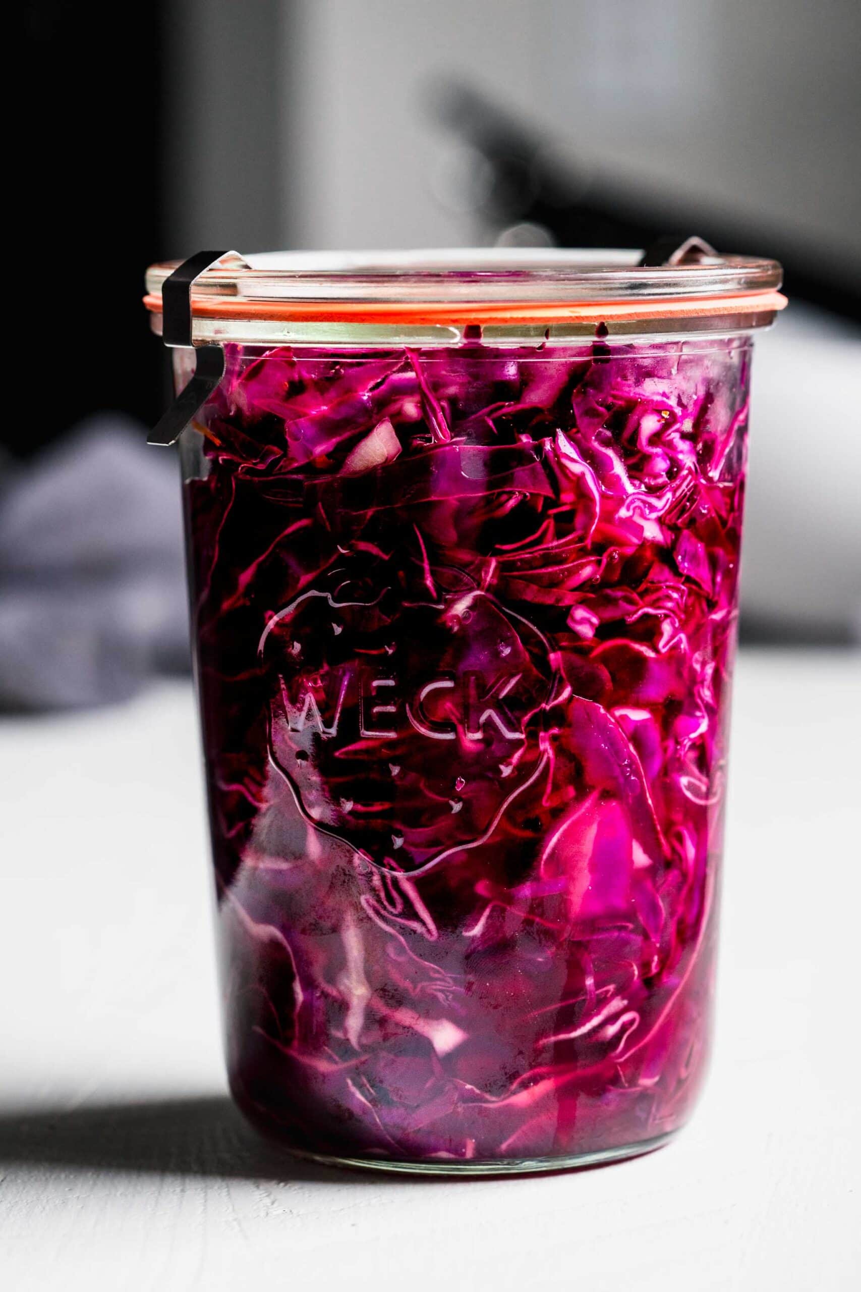 Side view of pickled red cabbage in jar.