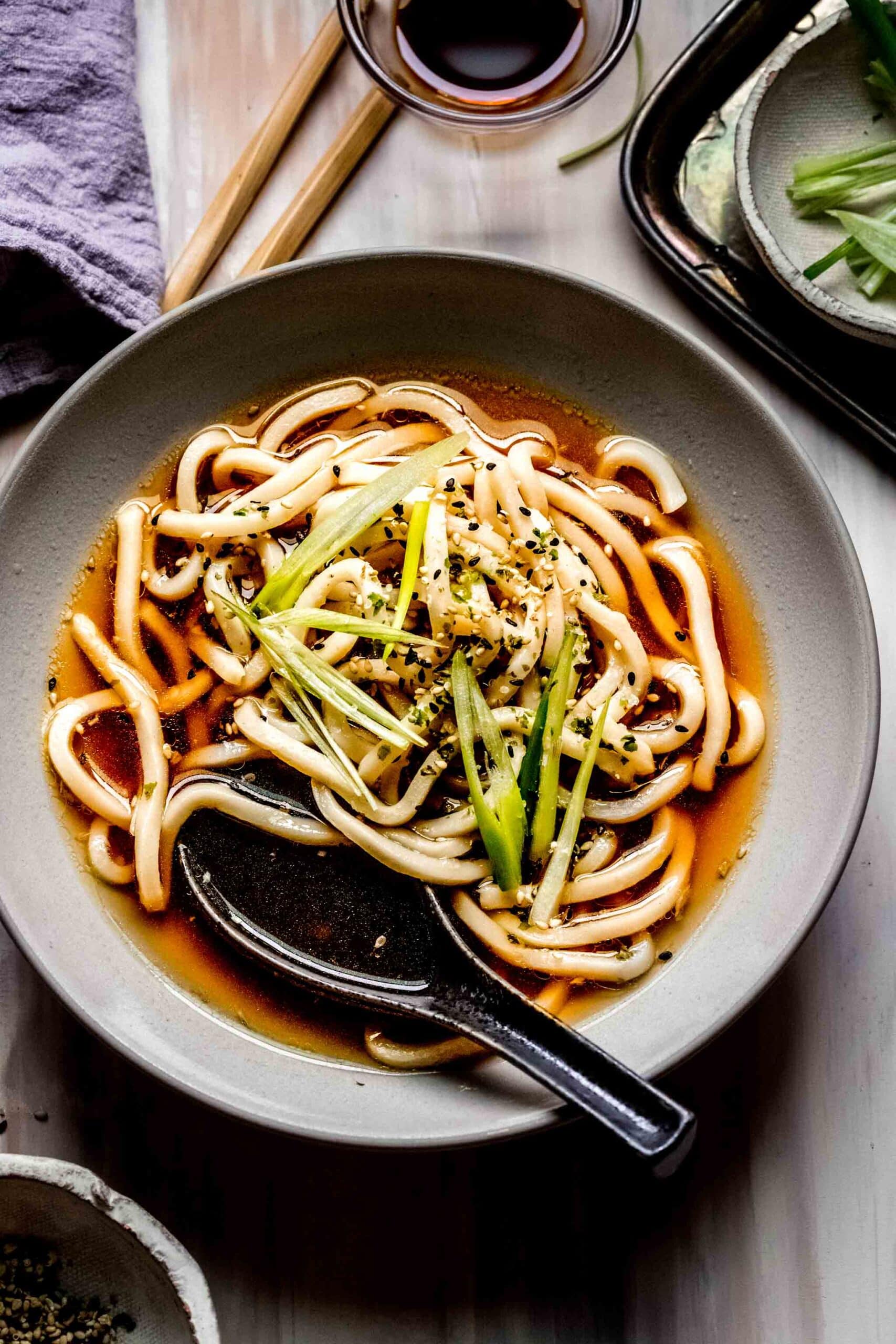 Overhead shot of bowl of udon soup with soup spoon.