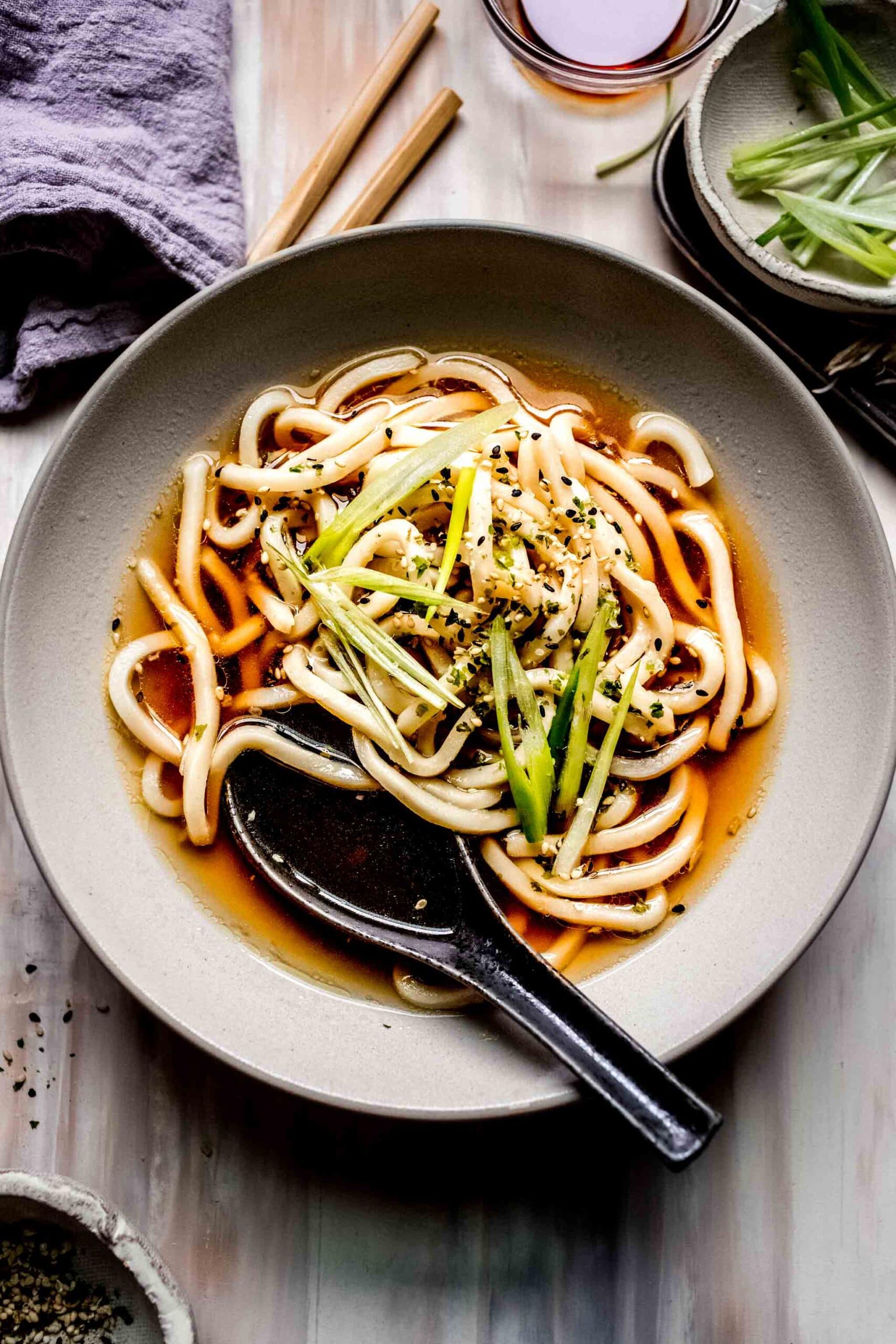 Overhead shot of bowl of udon soup with soup spoon.