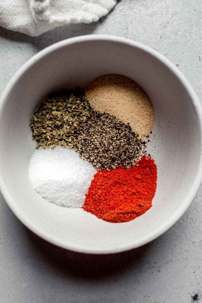 Spices for chicken drumsticks in small bowl before combining. 