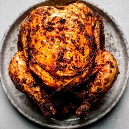 Crispy roast chicken on plate.