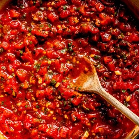Sauce with spoon in skillet.