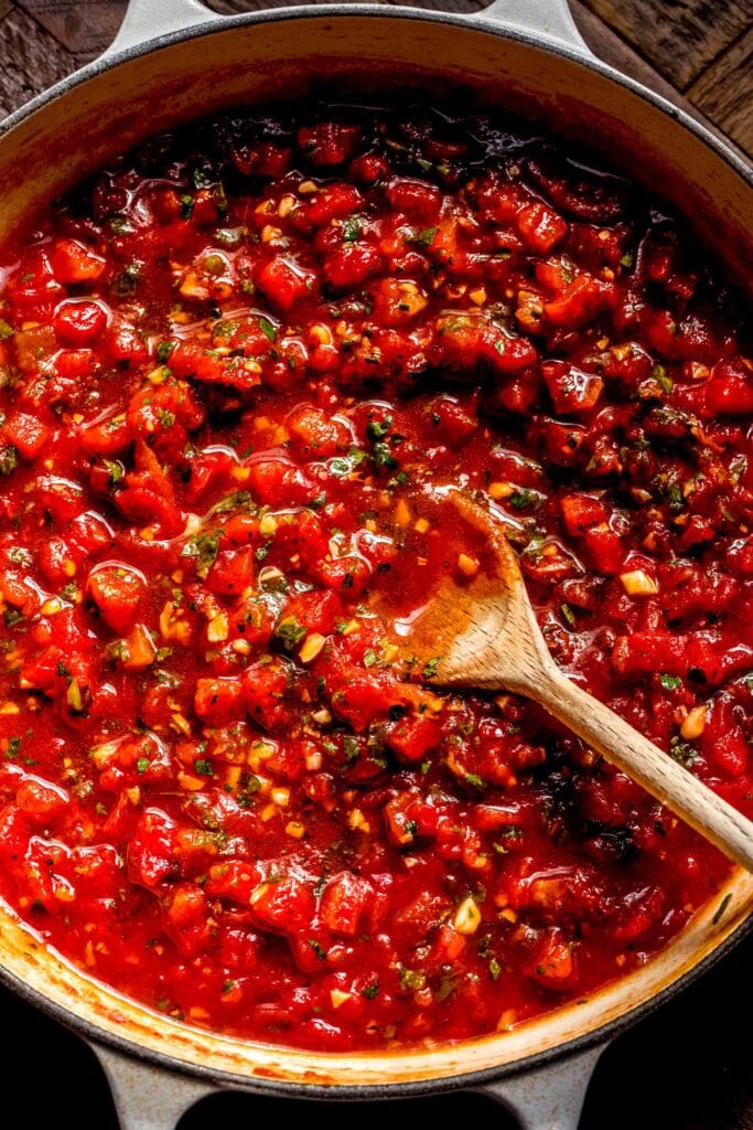 Sauce with spoon in skillet.