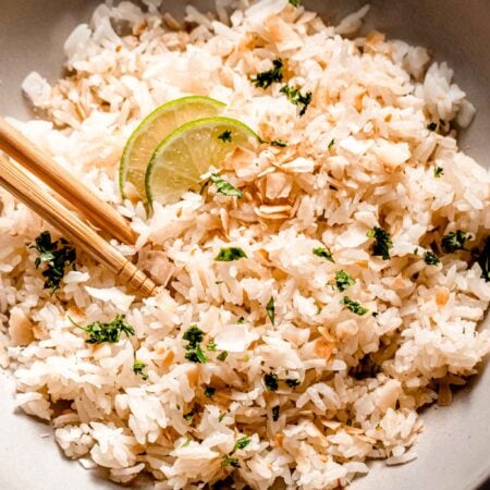 Overhead close up of bowl of lime coconut rice with chopsticks.