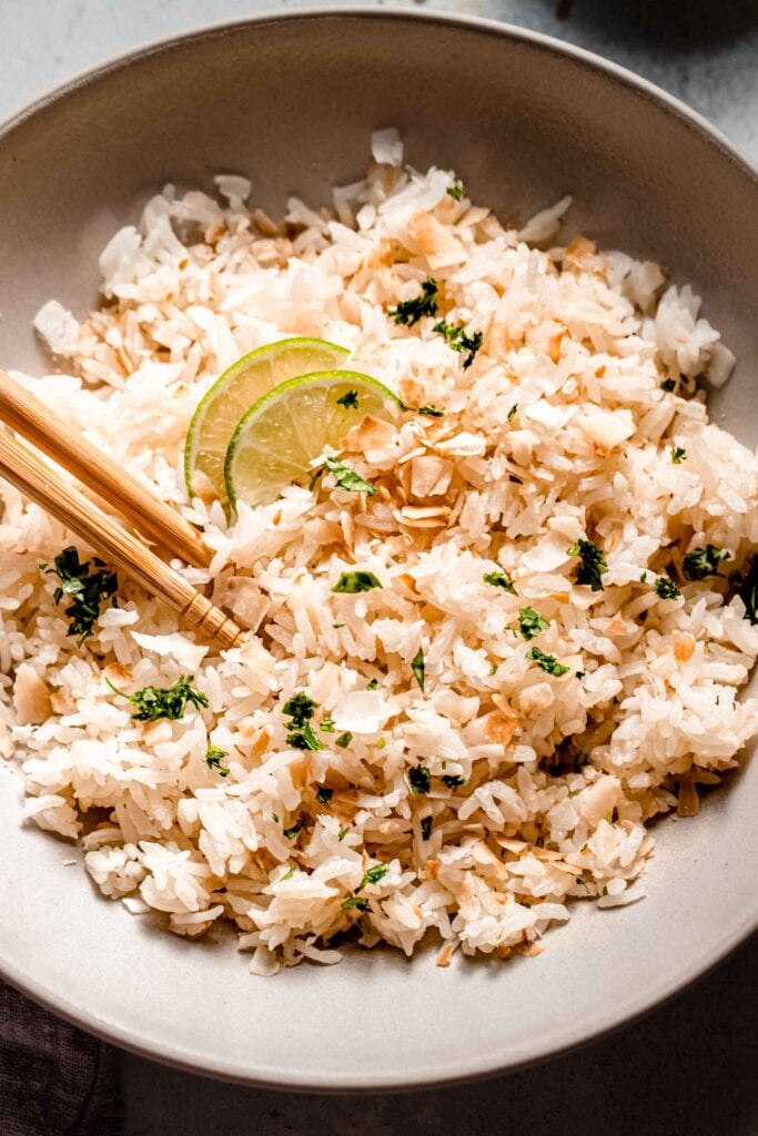 Overhead close up of bowl of lime coconut rice with chopsticks.