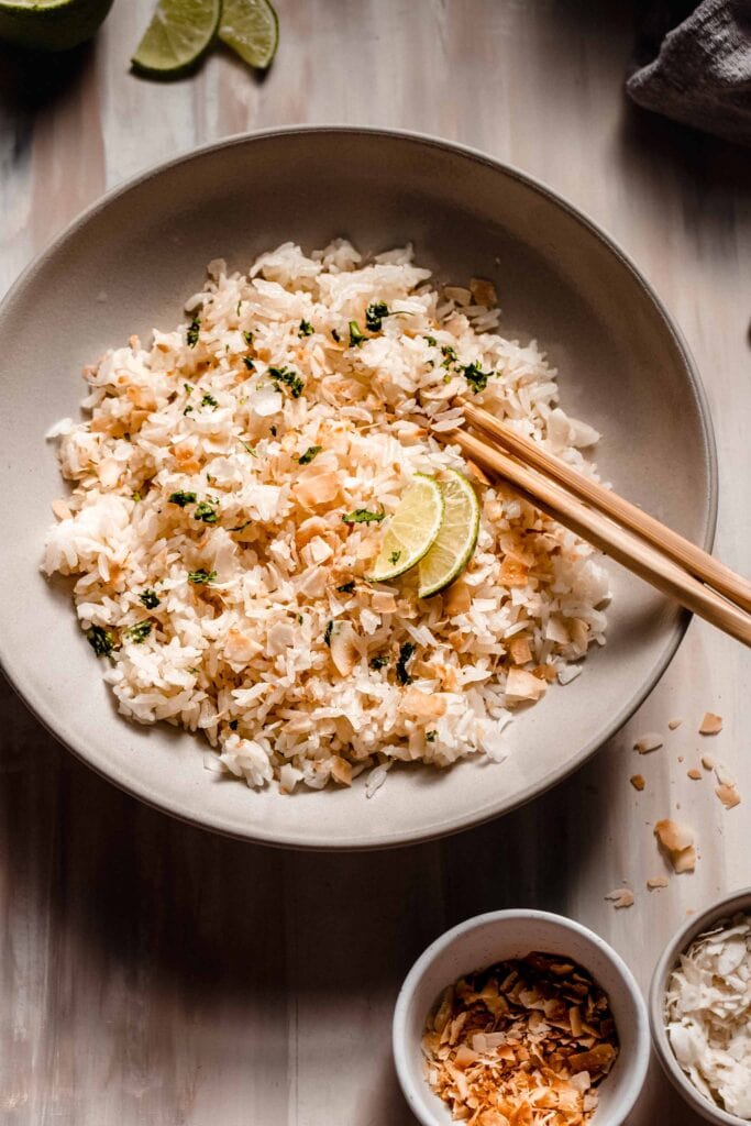Bowl of coconut lime rice with chopsticks.