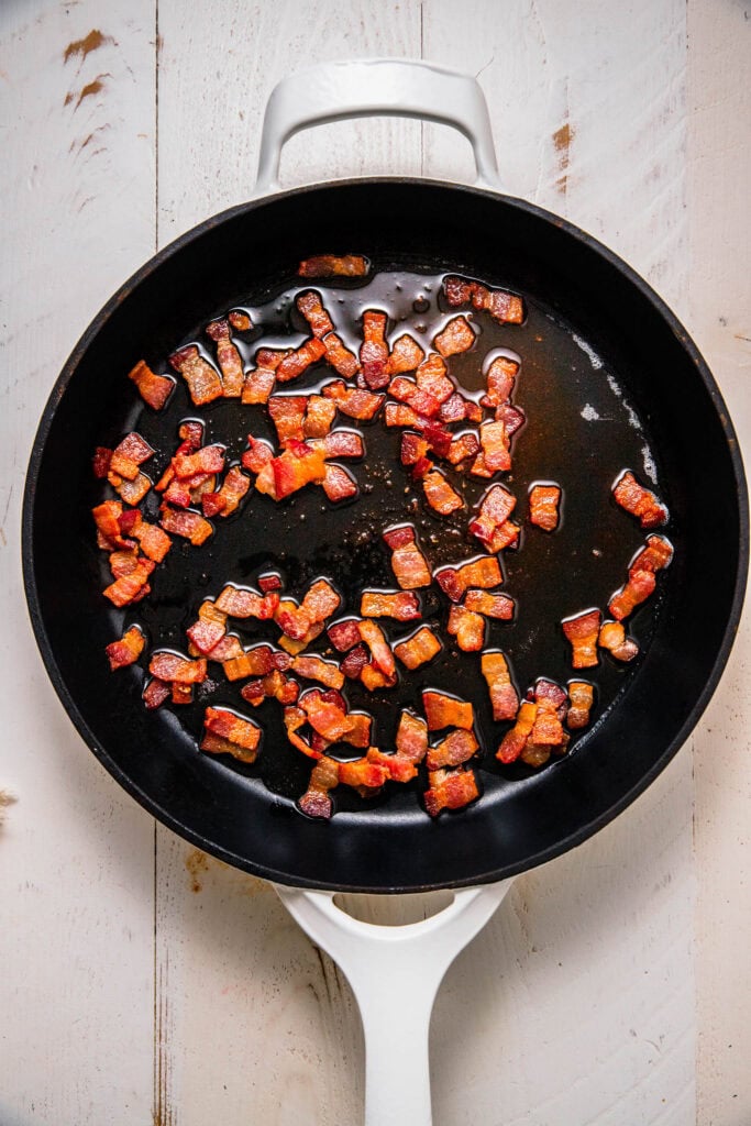 Bacon crisping in skillet.