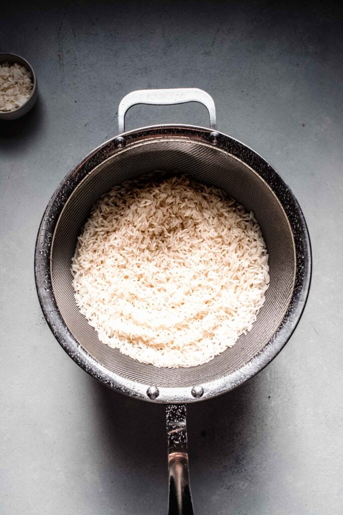 Rinsed rice in strainer.