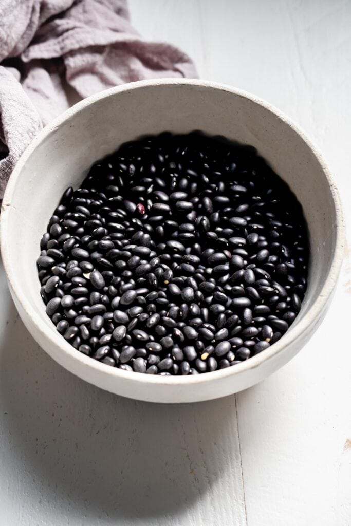 Dried black beans in bowl.