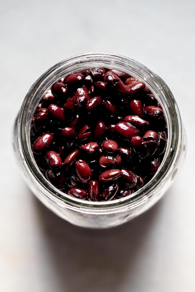 Overhead shot of black beans in jar.
