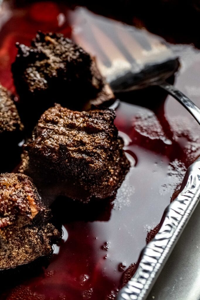 Side view of Beef short ribs in red wine bath.