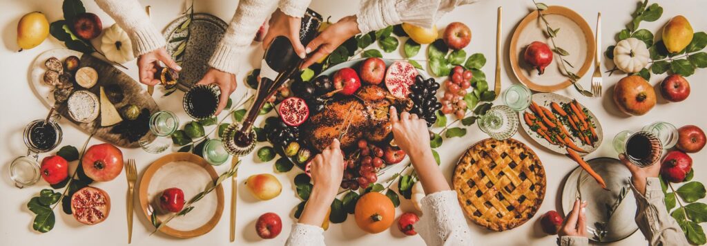 People dining at Thanksgiving table. 