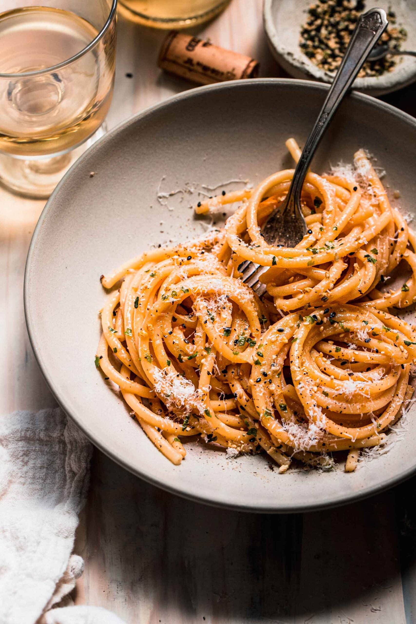 Miso pasta swirled in bowl with fork.