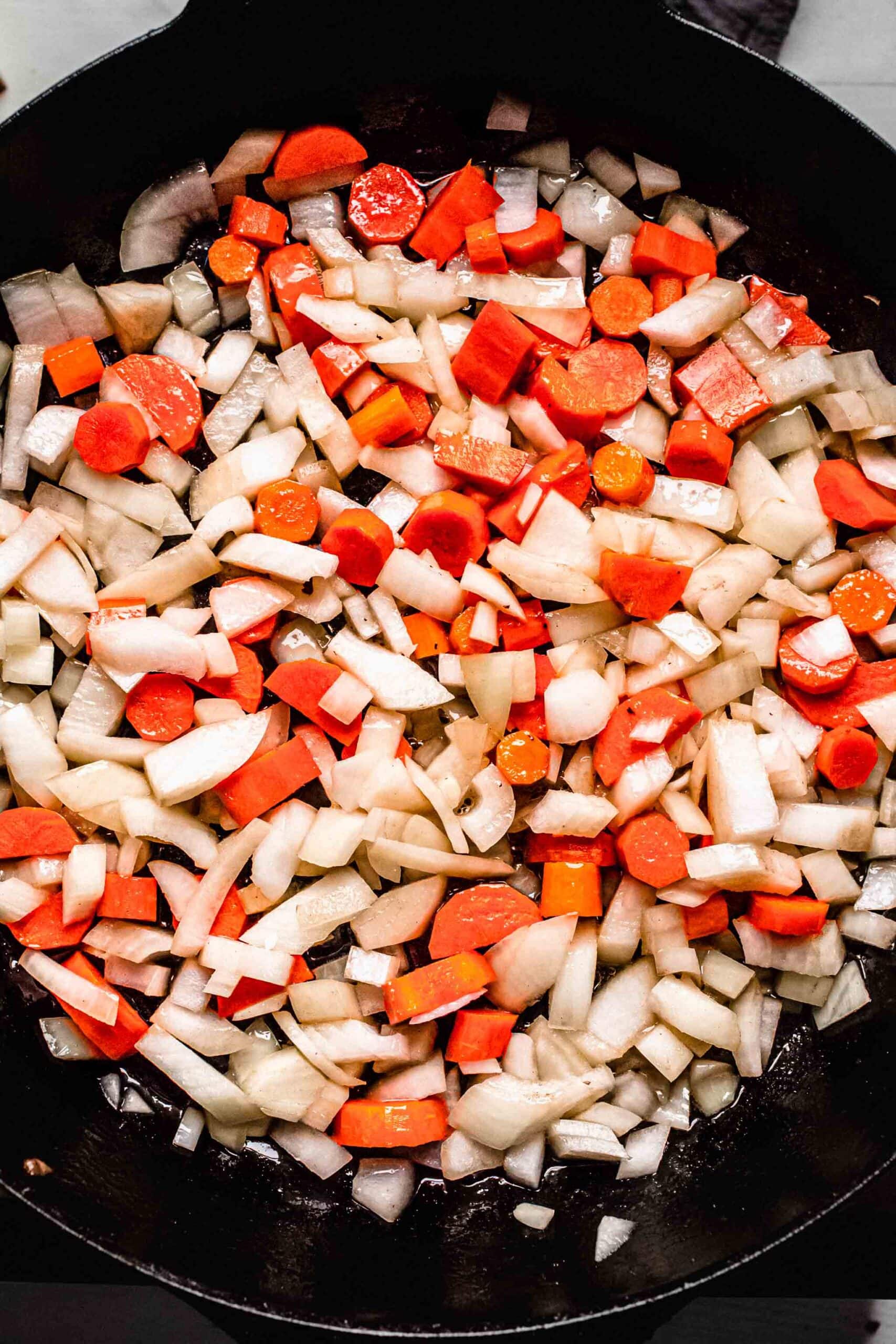 Sauteed carrots and onions in skillet.