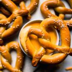 Soft pretzel dipped in cheese sauce.