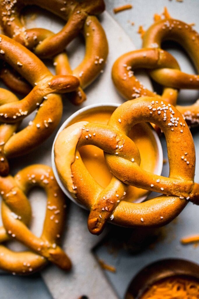 Soft pretzel dipped in cheese sauce.