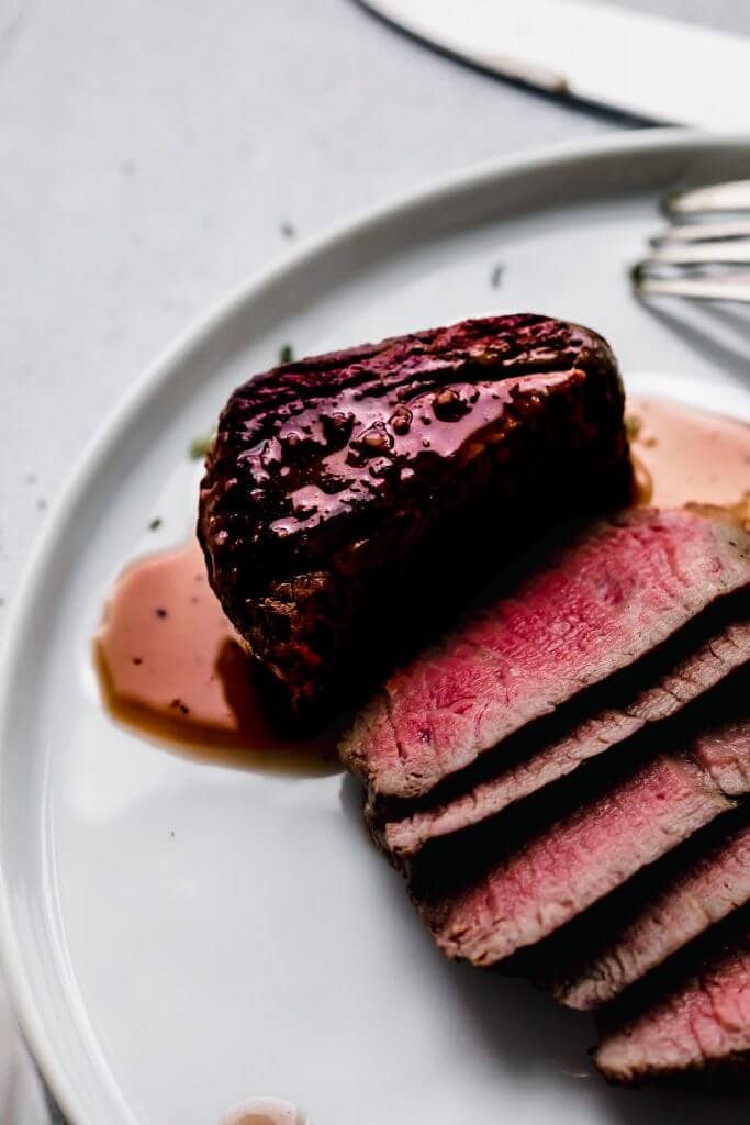 Filet mignon drizzled with red wine sauce. 