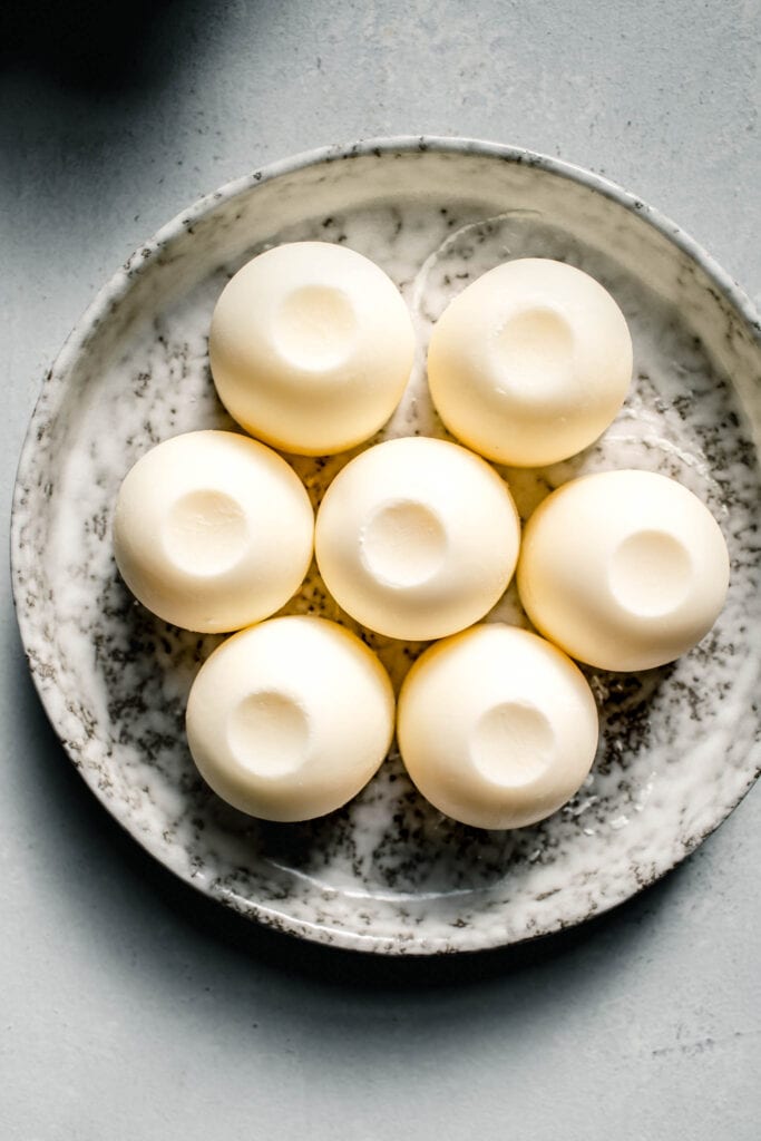 Frozen cubes of heavy cream on small plate.