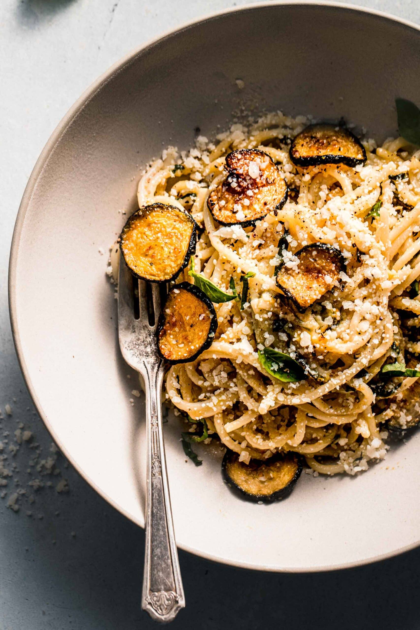 Overhead shot of spaghetti alla nerano in white bowl with fork.