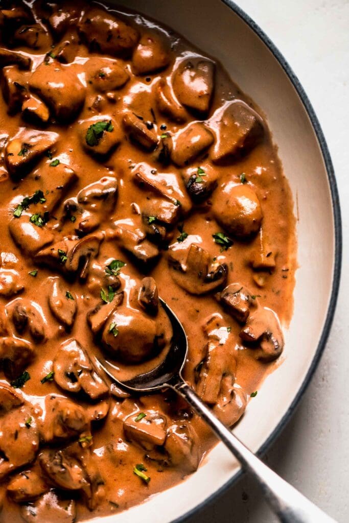 Close up of creamy mushroom sauce in skillet. 