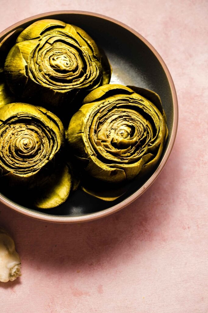 Cooked artichokes in serving bowl. 