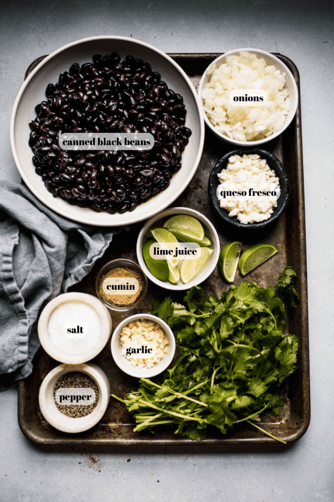 Ingredients for Mexican black beans labeled on tray. 