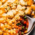 Overhead shot of shepherd's pie in skillet with scoop taken out of it.